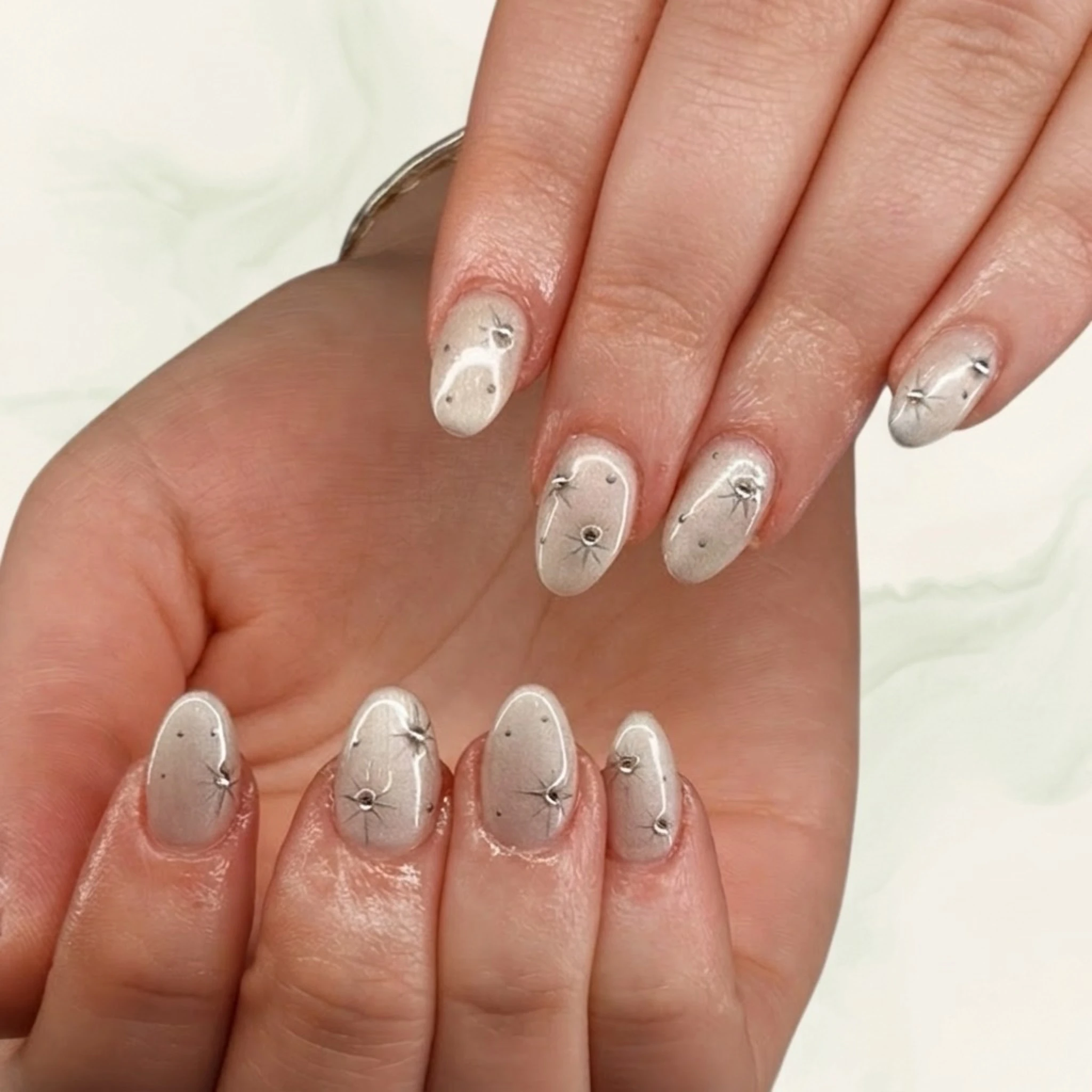 White marble nails with silver accents — elegant minimalist nail art